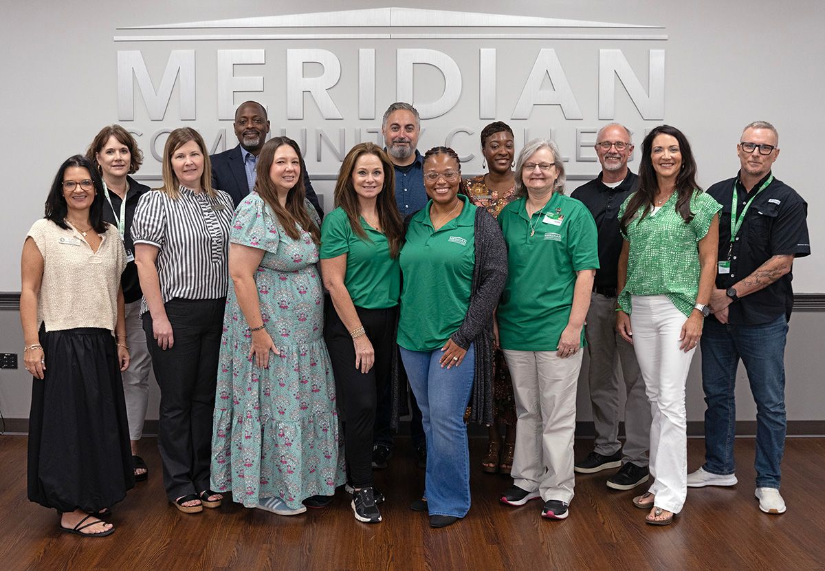 Eagles Leadership Convocation gathers for Class of 2027 photo. Front row from left are Dr. Leia Hill, Heather Ammon, Erica Stokes, Tracy Stockton, Mya Adams, Janet Parrett, and Brandi Pickett. Back row from left are Glenda Sanders, Will Nathan, Anthony D’Angelo, Marquita James, Dr. Tom Huebner, and Mark Brentnall. 