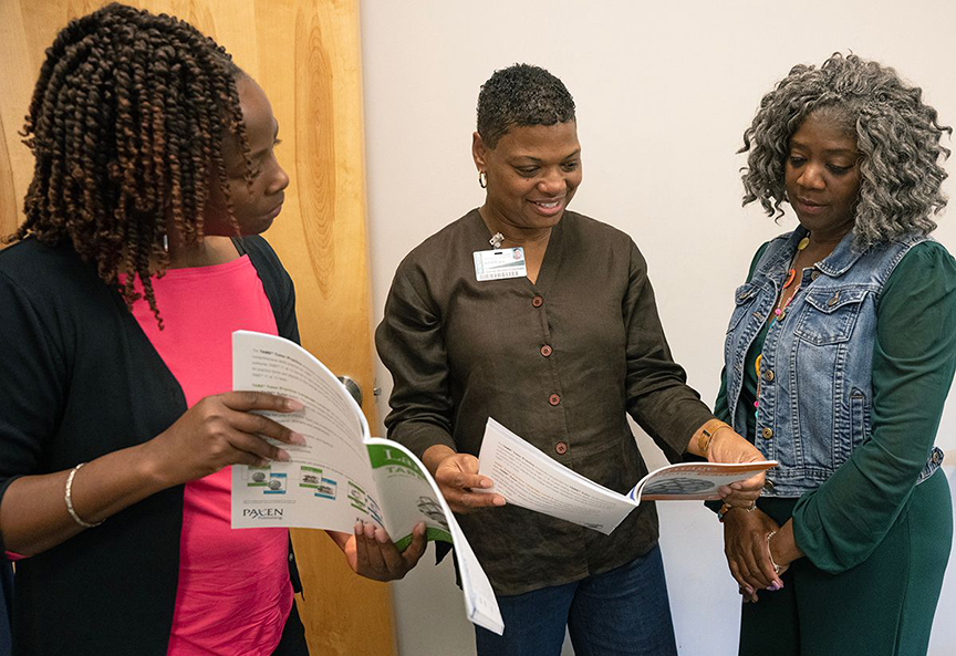 Rebecca Trussell, left, Jamila Brown Coleman, and Deborah Brown-Porter review materials used at the College’s Adult Education Department. 