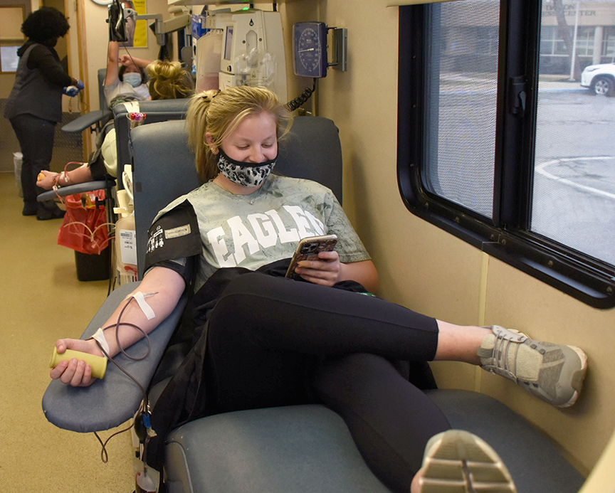 Sophomore Avery Byerley, 19, of D’Iberville, checks her phone while giving blood. Byerley was one the 70-plus MCC students, faculty and staff and community residents who participated in the campus blood drive. This was the first time for Byerley to give.