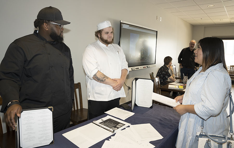 Quinton Lowery, left, and Henry Countiss, speak to Stephanie Valle during the MCC Culinary Job Fair. Valle is a second semester student in the College’s Culinary Arts Program; Lowery is a second-year student and a sous chef with Northwood Country Club. Countiss is the executive chef for the club. 