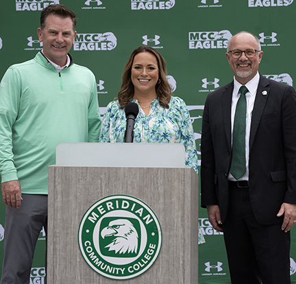 Angie Partridge, center, with Sander Atkinson, athletic director, and MCC President Dr. Tom Huebner. 