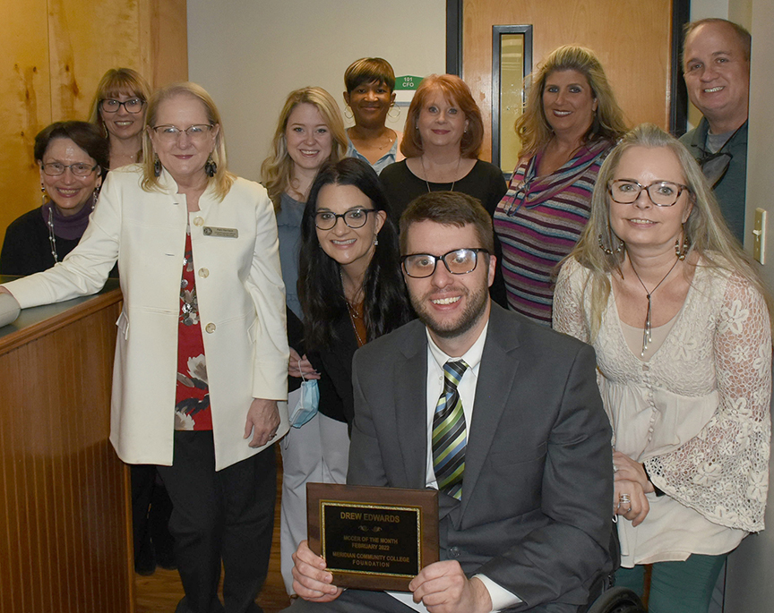 Joining Drew Edwards, center, in the MCCer of the Month celebration are Hardin Hall colleagues Diane Delk, Amanda Bratu, Pam Harrison, Callie Penson, Leia Hill, Crystal Webster, Stephanie Hollifield, Charlene Lewis, Cyndy Bratu and Gene Miles.