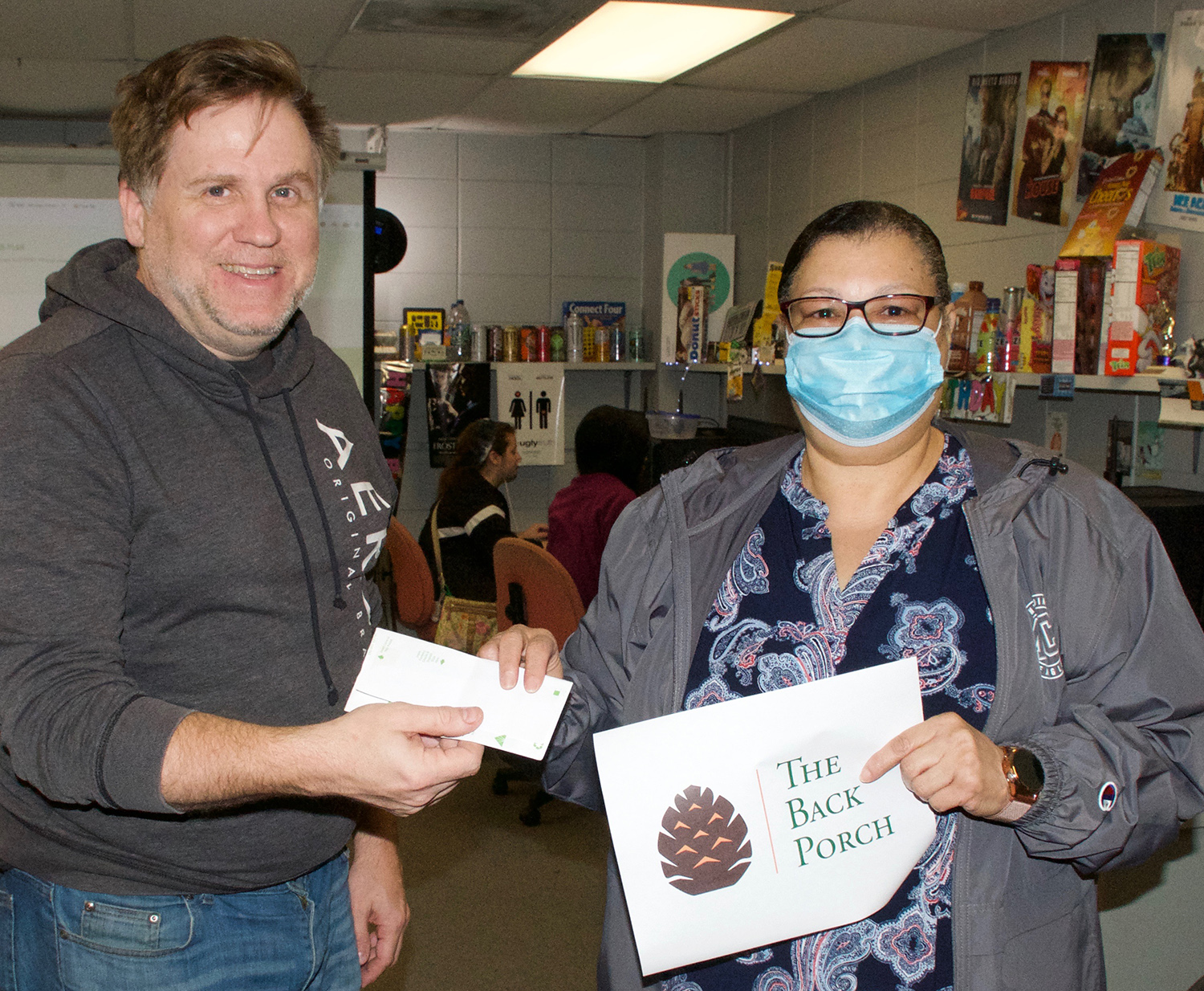 Graphic Design Technology Program Coordinator and Instructor Daniel Ethridge, left, presents Tamar Mosely with a cash award for her winning work for The Back Porch of Meridian.