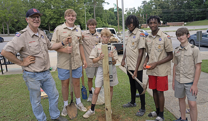 Pausing from their construction of the Little Free Library book-sharing box are Kendrick Prewitt, Scoutmaster, and Scouts Henry Prewitt, Warren Durgin, Jack Martin, Boston Hodges, William Hodges and Toby Robbins. 