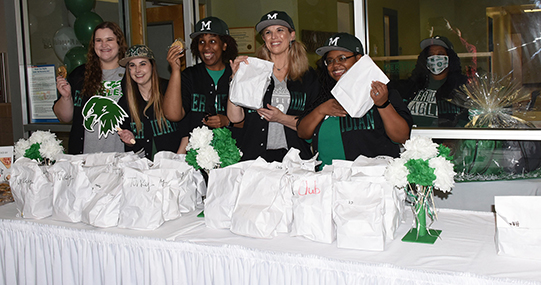 Greeting guests are Financial Aid staffers Taylor Croley, Lauren Stokes, Nedra Bradley, Lily Hatampa, Whitney Ross Stevens and Willie Davis.