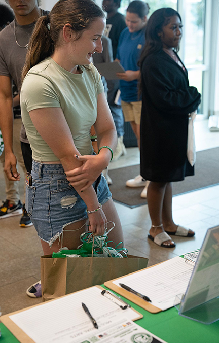 Holly Gillies looks around at the information booths during the latest orientation session, Liftoff. 
