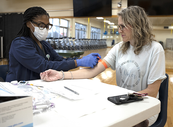 Billie Kidd, left, with Anderson WorkHealth, prepares to draw blood from MCCer Tanya Wright. The College’s Wellness Committee hosted its Wellness Screening and Health Fair in the Damon Fitness Center. 