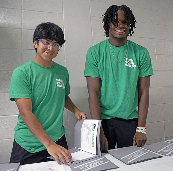 Otoniel Alonso left, and Kendrick Brown pause for a photo op while manning the check-in desk for new students at the latest MCC orientation. 