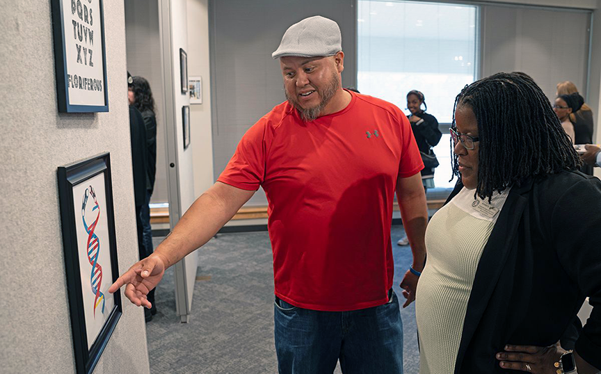 Kendril Wallace shows one of his designs to MCCer Kim Rush during the art student show and competition. Kendril Wallace shows one of his designs to MCCer Kim Rush during the art student show and competition.