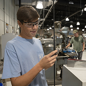 Student Tyson Marlow checks his work in his MCC Precision Machining Engineering Technology Program class. Marlow was one of the Top Five winners in his class challenge. 