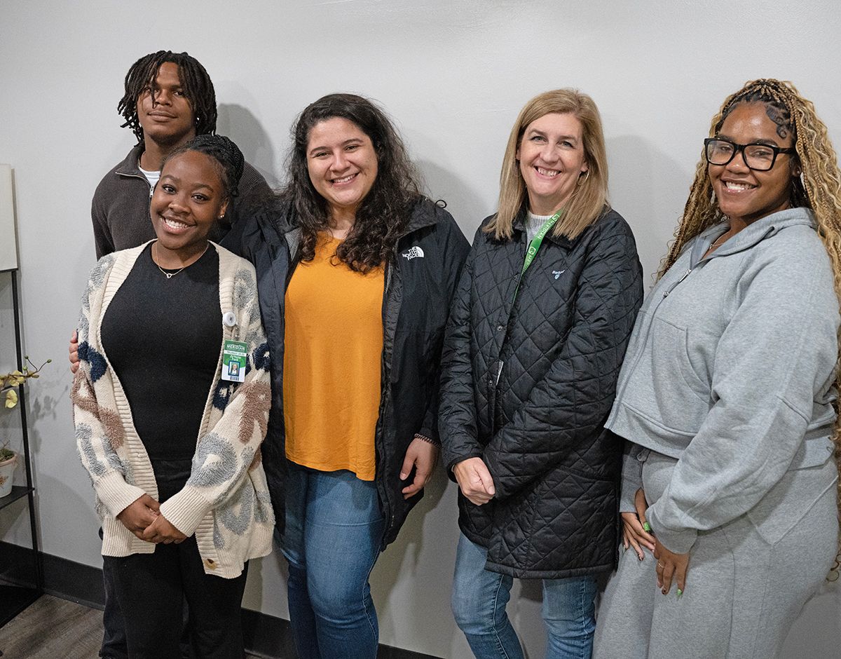 Carson Willis, left, Zy’Keria Ford, Kayla Fuentes, Jan Freeman, and Courtney Smith. The Meridian Collegiate Academy students visit with MCC staffers for informal mentoring sessions.