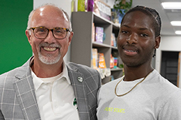 Two men smiling for a photo.