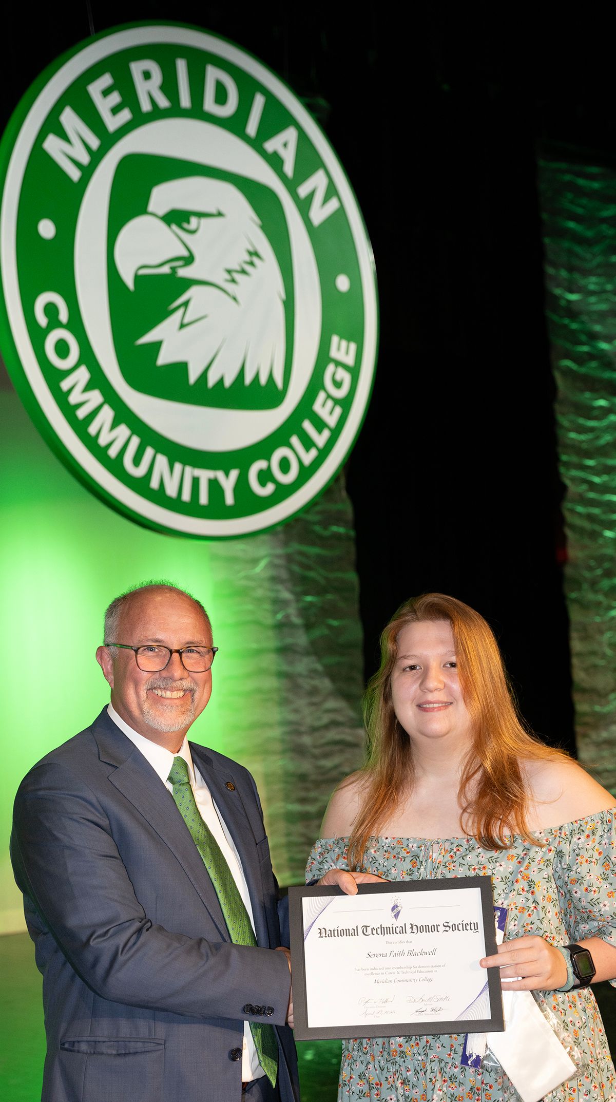MCC President Dr. Tom Huebner congratulates National Technical Honor Society inductee Serena Blackwell. 