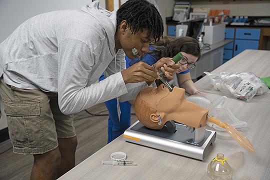 Meridian High School ninth grader William Davidson concentrates has he places a tube in a mannequin. Davidson was one of 60 students from MHS and Lauderdale County Schools who got a closer look at some of the health care programs offered at MCC as a part of a unique day-long camp, Experience the O.N.E. – Occupations Not Usually Explored by Men.  