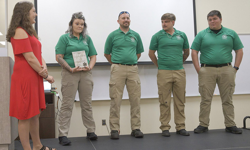 Instructor Sam Gellatly, left, congratulates Whitney Blackwell, John Hollingsworth, Trenton Evers, and William Lance Thompson for their work in the Emergency Medical Services Paramedic Program. 