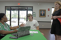 Kimberly Rush, left, associate dean of advising, retention and student success, talks to Will Schular and his mom Mary Taylor about his Fall Semester 2023 scheduled during Parent/Family Information Night. 
