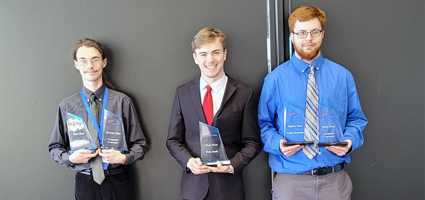 With their trophies are Dyson Williams, left, Stephen Milling, and Brayden Stewart. The three won awards from the Phi Beta Lambda national conference. 