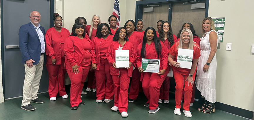 At the phlebotomy completion ceremony are back row from left MCC President Dr. Thomas Huebner, Emma City, Wandalla Campbell, Lorin Greene, Shelley Boyd, Wanda Smith, Shannon Reynolds, Allexus Hamilton, and Phlebotomy Instructor Krystal Holifield. Center row from left are Marquelle Blanks, LaBreasha Scott, Natina Norman, and Baileigh Primeaux. Front row from left are Yolanda Randle, Justice Harris, and Bethany Junkins.