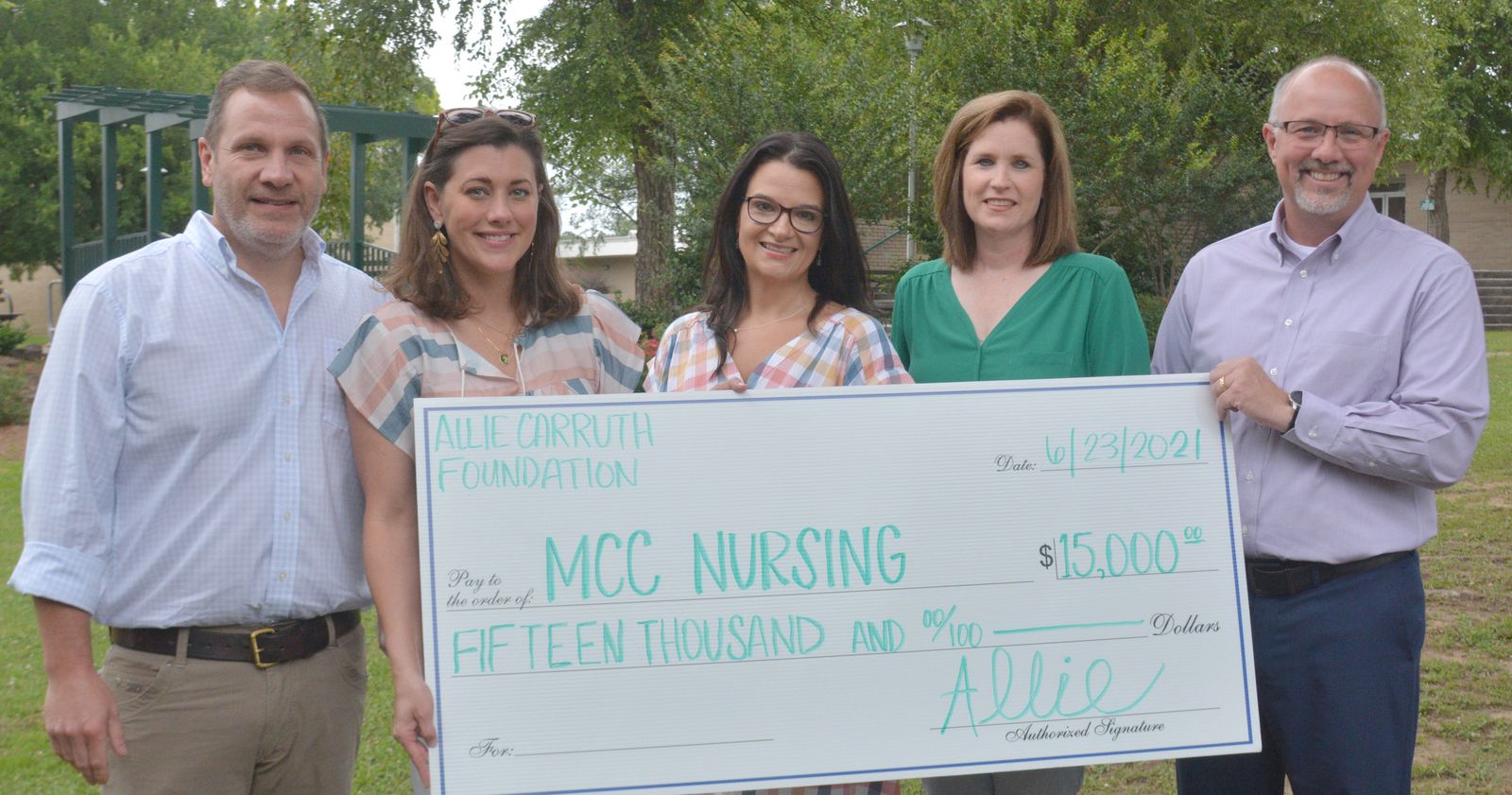 Signing their daughter’s signature on a symbolic check, Leslie and Bill Carruth donated $15,000 to Meridian Community College’s Associate Degree Nursing Program. 