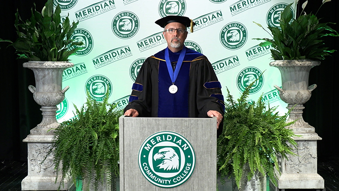 Dr. Huebner addressing graduates 