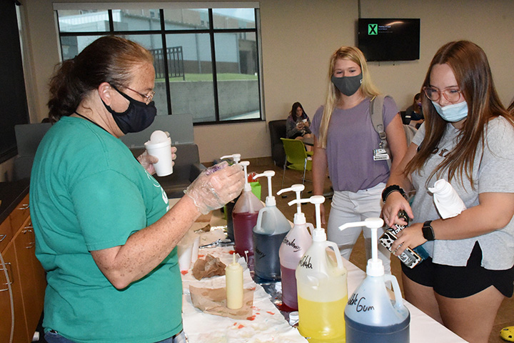 LeAnne Motes dishes out snow cones as students line up for their treat.  