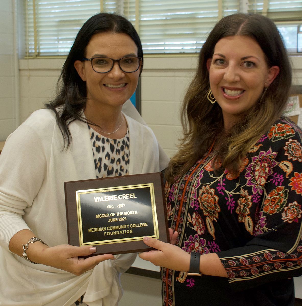 Leia Hill presents Valerie Creel with MCCer of the Month Award