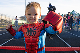 A child dressed in a Spiderman costume.