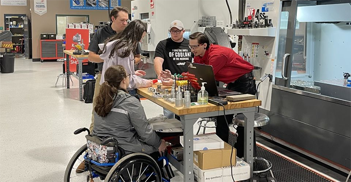 Students gather in MCC’s Gene Haas Advanced Manufacturing Center to put the finishing touches on their work for the Design Build Collaboration Challenge for ProjectMFG. 