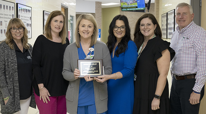Joining in the announcement of Samantha Shelby as MCCer of the Month for February are, from left, Amanda Bratu, Dr. Lara Collum, Shelby, Leia Hill, Rebecca Higginbotham, and Joseph Knight. 