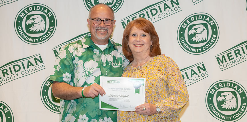 Dr. Thomas Huebner, left, congratulates Stephanie Holifield on her 20-year work anniversary. Holifield was one of 50 MCCers saluted for their years of service to the institution.