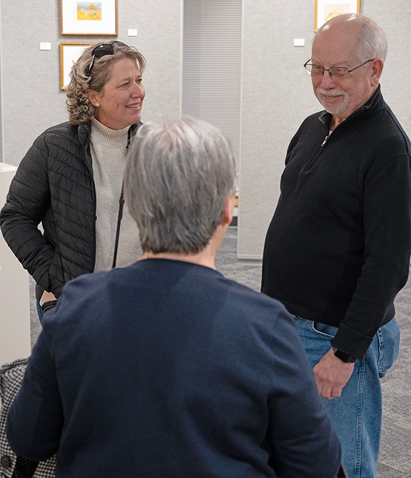 Jimmy Smith, right, talks to guests at art opening. Smith uses the nom d’art of Robert Hale-Smith. 