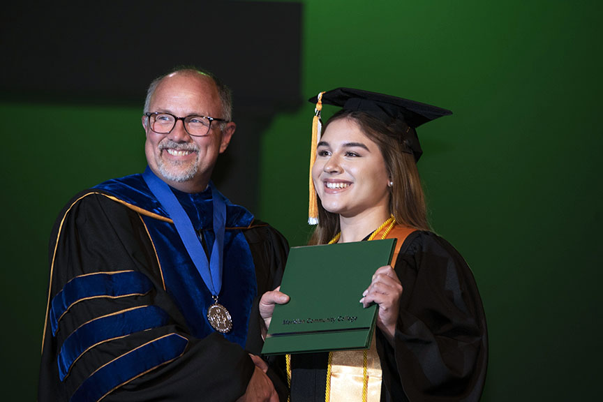An MCC grad, right, and MCC President Dr. Thomas Huebner are all smiles during one of the University Transfer graduation. The College hosted two commencement ceremonies for the Class of 2022.
