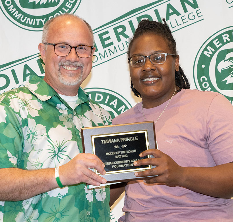 MCC President Dr. Thomas Huebner, left, presents Tia’Wana Pringle with her MCCer of the Month plaque. Pringle was selected as the honoree for May.