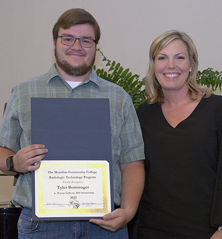 Tyler Borntrager, left, with MCC Radiologic Technology Clinical Instructor Jerri Spears during a presentation ceremony.