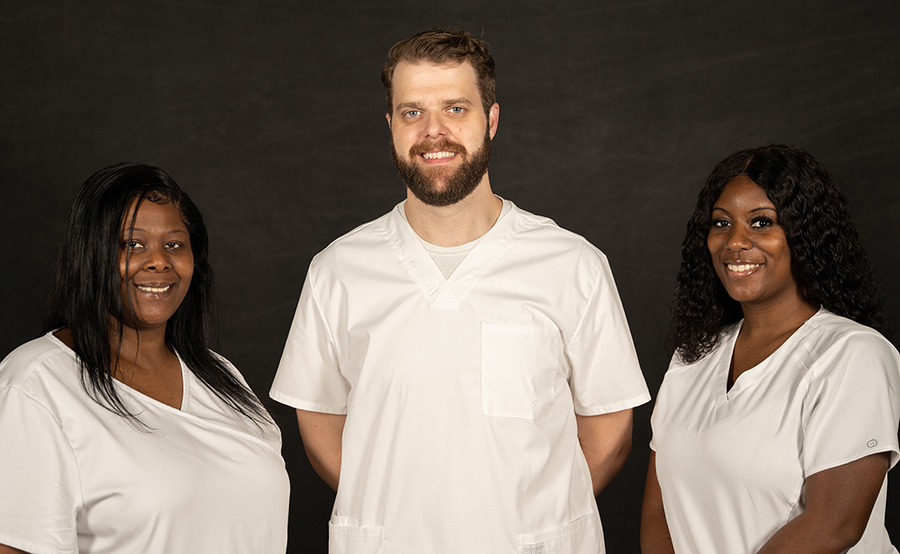 Associate Degree Nursing Program graduates Monica Anthony, left, Alan Rigdon, and Marquita Smith also received vouchers. 