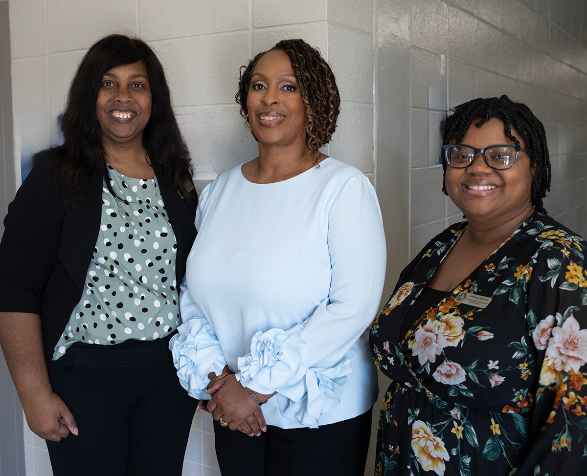 Nedra Bradley, left, and Whitney Stevens, right, with Women’s History Month Program speaker Janice Robinson. 
